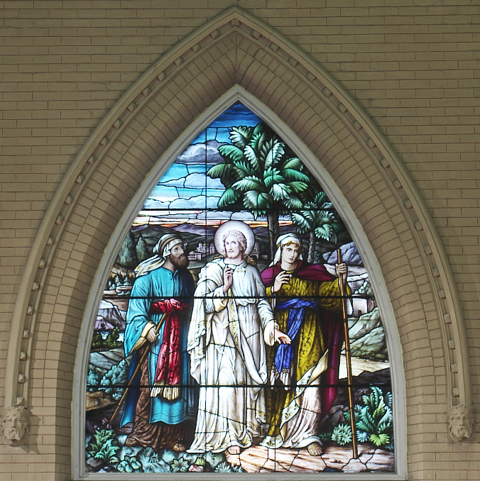 Stained glass wndow representing Jesus and 2 disciples on the road to Emmaus (Luke 24)